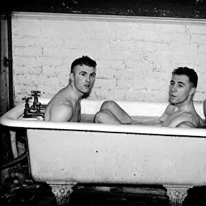Everton footballers (left-right) JN Cunliffe, C Button and W Cook in the bath after