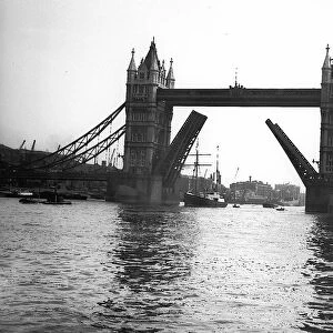 The expedition ship Sir E Shackleton sails through the open roadway of Tower Bridge into