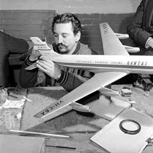 Factory where model aircraft for the travel agents are made. Men making model planes