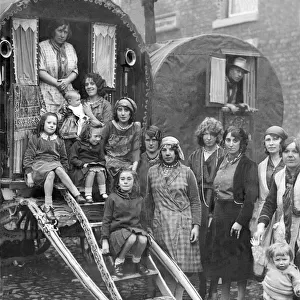 Families of gypsies outside their caravans at Yarm Fair in October 1931