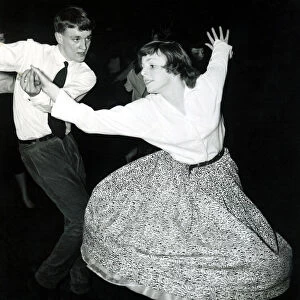 Fifties dancing - Skirt flared out as girl is spun around by her partner at the dance
