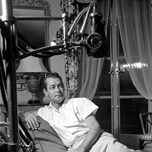 Film star Alan Ladd, who has injured his foot. October 1953 D6473-001