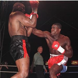Frank Bruno strikes Oliver McCall with a right hook during their fight for