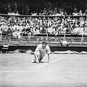 Fred Perry falls yet smiles on the court at The Wimbledon Mens Tennis Championships 1935