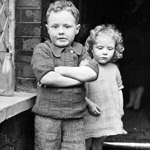 Freddie Harrison, 6, and his sister Winifred, 3, whom he saved from the ruins of their