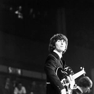 George Harrison of The Beatles on stage at the Palais des Sport in Paris. June 1965