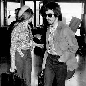 George Harrison at Heathrow Airport today with his wife Patti Boyd. November 1973 P003740