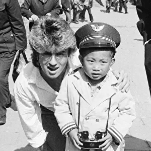 George Michael from Wham ! and a Chinese Boy on The Great Wall of China, in China. 1985