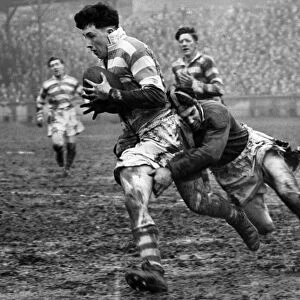 Harry Street of Wigan being tackled by G. Kibroy of Batley