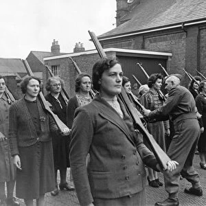 A Home Guard Sergeant giving women instructions on holding rifles during a drill