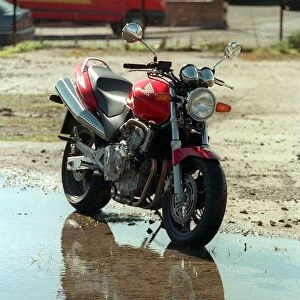 The Honda Hornet 600CC Motorbike April 1998 reflecting in water puddle