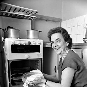Household - Domestic Chores Cooking. A woman using her gas over in the kitchen of her