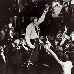 Jerry lee Lewis Singer - performing on stage, surrounded by fans - singing