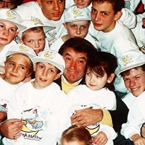 Jimmy Tarbuck TV Presenter Comedian at Heathrow with handicapped children who are on a
