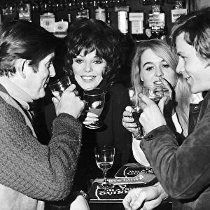 Joan Collins Actress enjoying a drink with Ray Barrett Sinead Cusack