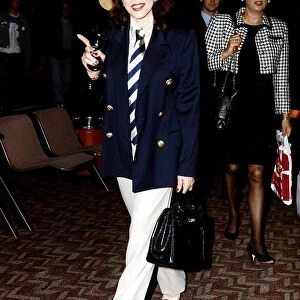 Joan Collins Actress Walking throuh Airport holding black bag