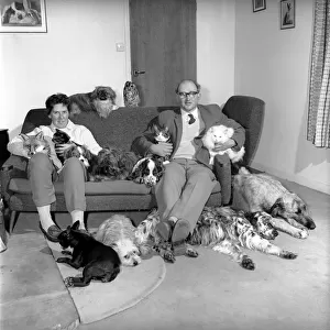 John Holmes seen here with his wife and surrounded by all his pets, which includes dogs