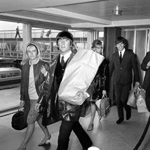 John Lennon and his wife Cynthia arrive back at London Airport from their holidays