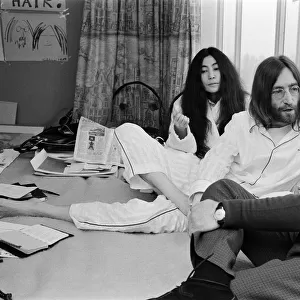 John Lennon and his wife Yoko Ono stage a bed in on their honeymoon
