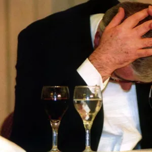 John Major attending the Leeds Chamber of Commerce and Industry dinner. Head in hands