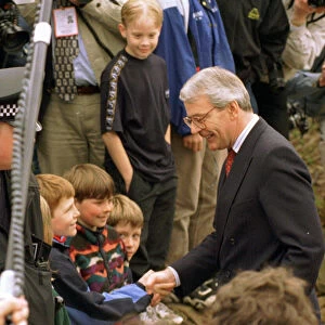 John Major shaking hands with small boy during his visit to Gretna Green April 1997