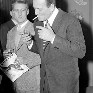 John Wayne in London lighting a cigarette February 1956