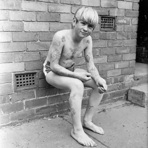 Joseph Daugherty, aged 14, showing off some of his 60 tattoos