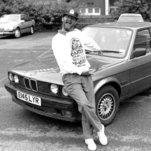 Kenny Everett sitting on bonnet of his new BMW car 21 / 07 / 1989
