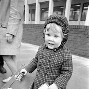 Little boy holding on to a suitcase. November 1969 Z11024-005