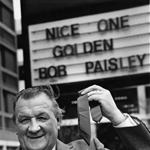 Liverpool manager Bob Paisley proudly displays his latest award as "