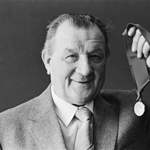 Liverpool manager Bob paisley proudly displays his latest award as "