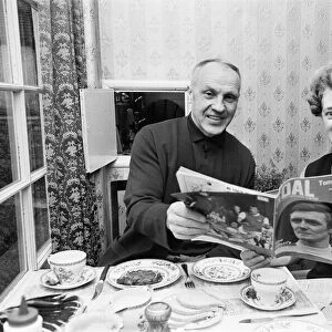Liverpool manager Bill Shankly pictured at home with his wife reading a feature