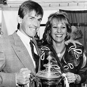Liverpool player manager Kenny Dalglish holding the FA Cup trophy with his wife Marina