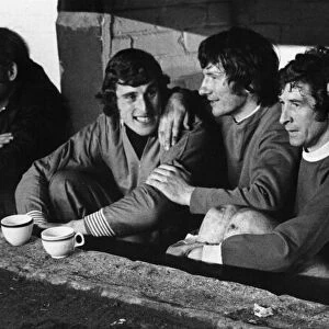 Liverpool players on the bench watching as Bill Shankly takes the field in the half time