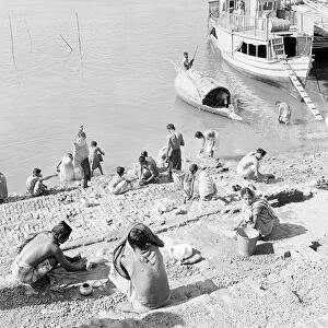 Locals bath in the Buriganga River Dacca, Bangladesh. February 1961 l