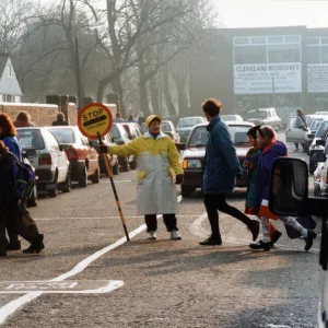 Lollipop lady Susan Hall escorts children across Crescent Road, Worcester Street Crossing