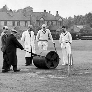 Longsight Cricket Club, Lancashire. Ground staff prepare the wicket while players