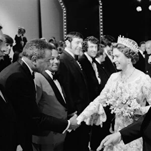 Her Majesty Queen Elizabeth II, escorted by Media mogul Lew Grade (right)