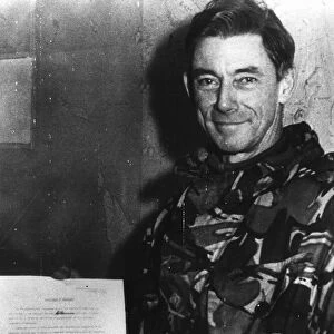 Major General Jeremy Moore holds the surrender document signed by General Mario Menendez