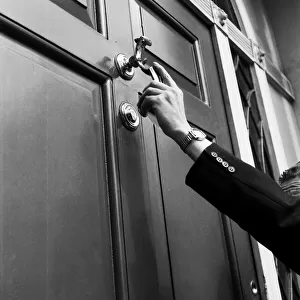 A man knocking on a door. September 1955