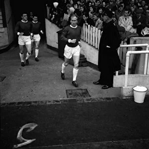 Manchester United footballer Bobby Charlton runs out on to the pitch for the league match
