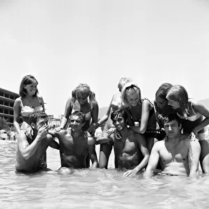 Manchester United footballer George Best with friends including Mike Summerbee cool off