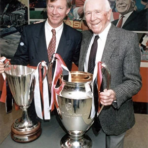 Manchester United manager Alex Ferguson and former manager Sir Matt Busby posing with