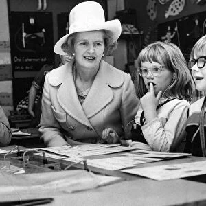 Margaret Thatcher sits with children taking a reading class at the Northern Councties