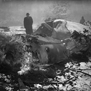 A member of the air Intelligence branch of the war office inspect the wreckage of a