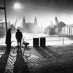 Two men talking as they stand in princes Dock in Central Liverpool