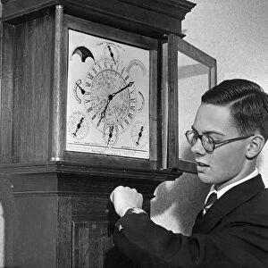 Michael Finnemore checks his watch by his Wonder grandfather clock before it is