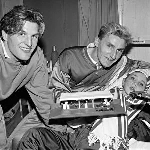 Middlesbrough footballers, Tony Mowbray (right), hand out presents to children at