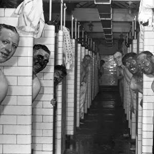 Miners in the pithead baths following a shift underground at Mosley Common Colliery