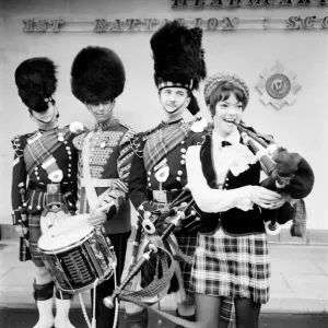 Black and white print of a young woman attempting to play the bagpipes Black and white print of a young woman attempting to play the bagpipes